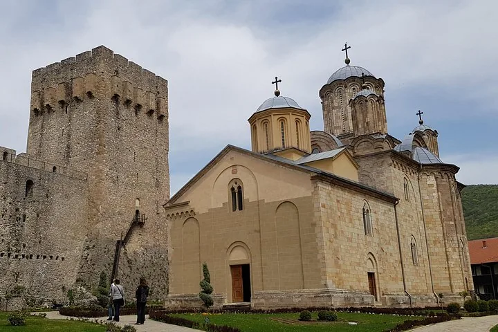 Manasija Monastery church standing next to towering stone fortifications